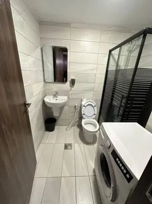 a bathroom with a toilet and a sink at Stylish Luxe Apartment F/R 0005 in Amman