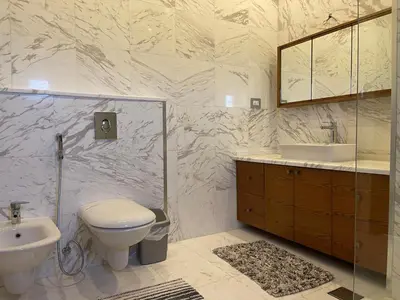 a bathroom with a toilet and a sink at Horizon Loft in Bilāl