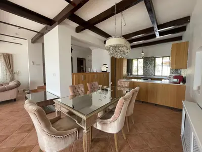 a dining room with a glass table and chairs at Horizon1 in Amman