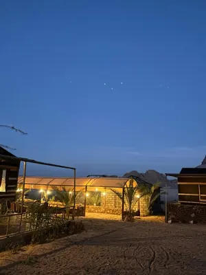 a view of a building at night at Wadi Rum Sarab Camp in Disah