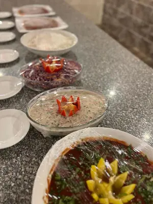 a table with plates of food on a counter at Wadi Rum Sarab Camp in Disah