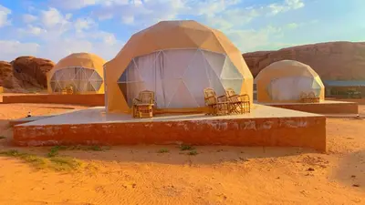 a tent in the desert with chairs in it at Wadi Rum Sarab Camp in Disah