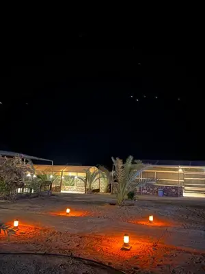a group of candles sitting on the ground at night at Wadi Rum Sarab Camp in Disah
