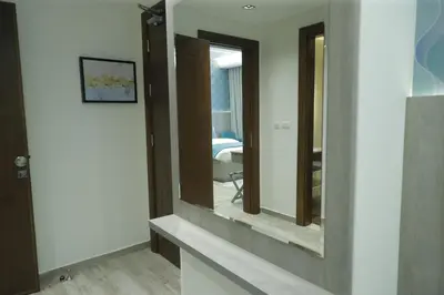 a bathroom with two mirrors on a wall at Soho Midtown in Ash Shumaysānī