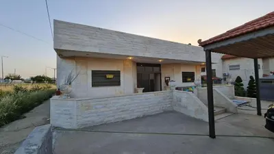 a small house with a large patio in front of it at Laura's Stylish Villa in Madaba
