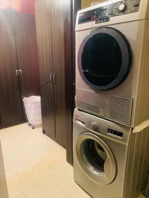 a microwave sitting on top of a washing machine at Laura's Stylish Villa in Madaba