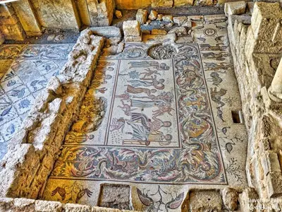 a mosaic floor in a building with a mosaic at Laura's Stylish Villa in Madaba