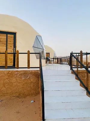 a staircase leading to a yurt on the beach at Omar Camp Wadi Rum in Disah