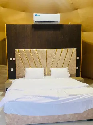 a large bed with white sheets and pillows at Omar Camp Wadi Rum in Disah