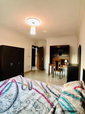 a bedroom with a bed and a dining room at Super modern comfortable apartment at the heart of historic Amman in Amman