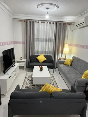 a living room with two couches and a tv at Super modern comfortable apartment at the heart of historic Amman in Amman