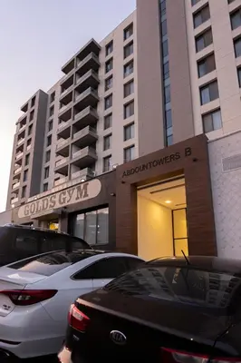 a building with cars parked in front of it at Luxurious in Abdoun Tower at 11th Floor in Amman