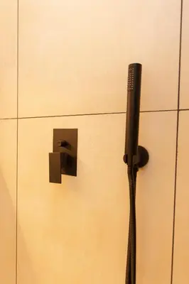 a blow dryer attached to a wall with a plug at Luxurious in Abdoun Tower at 11th Floor in Amman