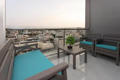 a balcony with benches and a view of a city at Luxurious in Abdoun Tower at 11th Floor in Amman