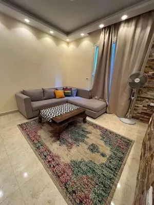 a living room with a couch and a coffee table at Holy land in Amman