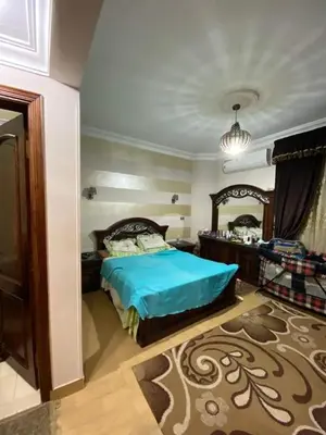 a bedroom with a bed and a large mirror at Holy land in Amman
