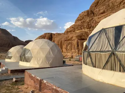 a group of three domes in the desert at Camp safaa rum in Wadi Rum