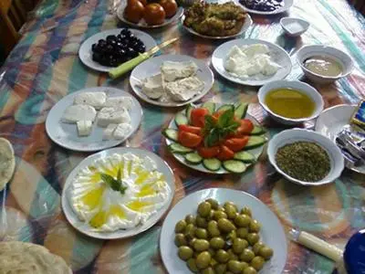 a table with plates of food on a table at look house in Amman