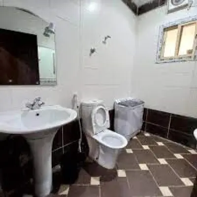 a bathroom with a toilet and a sink at look house in Amman