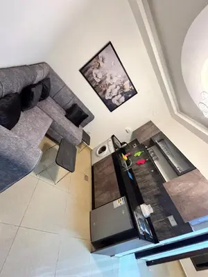 a living room with a couch and a table at Luxury Hotel apartment in Amman