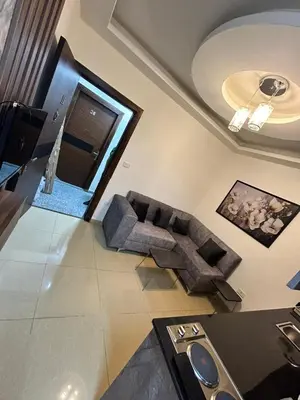 a living room with a couch and a table at Luxury Hotel apartment in Amman