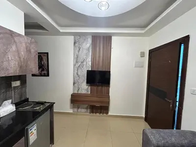 a living room with a tv on the ceiling at Luxury Hotel apartment in Amman