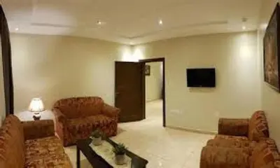 a living room with couches and a flat screen tv at 2332 Guest House in Irbid