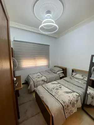 a bedroom with two beds and a ceiling at Nerman home in ‘Awjān ash Shamālī