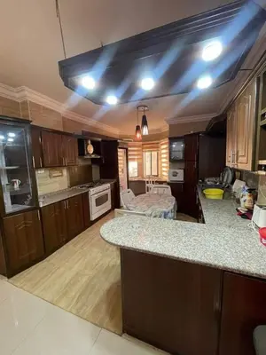 a kitchen with a counter top and a kitchen island at Nerman home in ‘Awjān ash Shamālī