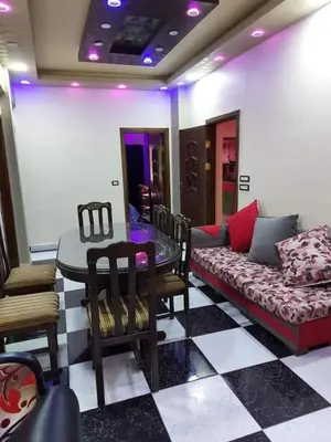 a living room with a couch and a table at Araregj home in Amman
