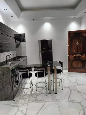 a kitchen with a table and chairs and a stove at Araregj home in Amman