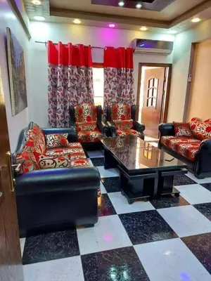 a living room with couches and a table at Araregj home in Amman