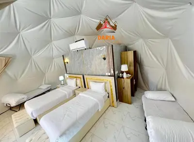 a room with four beds in a tent at Daria Luxury Camp in Wadi Rum