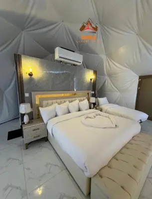 a bedroom with a large bed in a tent at Daria Luxury Camp in Wadi Rum