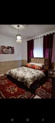 a bedroom with a large bed and a window at Maan 12 in Ma‘ān