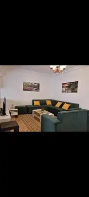 a living room with couches and a table at Maan 12 in Ma‘ān