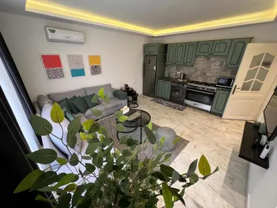 a living room with a couch and a table at Casa De Centre 1 in Amman