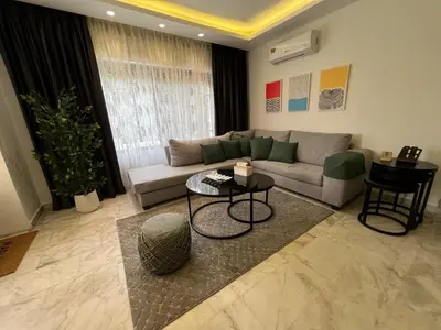 a living room with a couch and a table at Casa De Centre 1 in Amman