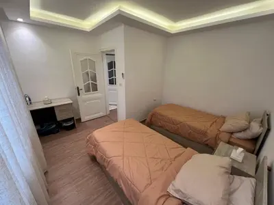 a small room with two beds and a desk at Casa De Centre 1 in Amman