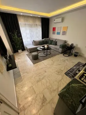 a living room with a couch and a table at Casa De Centre 1 in Amman
