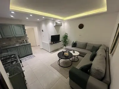 a living room with a couch and a table at Casa De Centre 2 in Amman