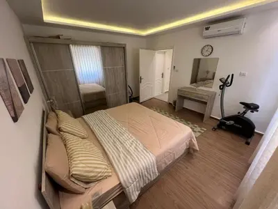 a bedroom with a large bed and a mirror at Casa De Centre 2 in Amman