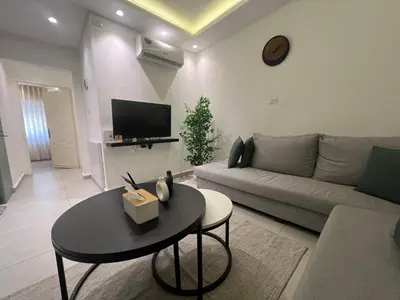 a living room with a couch and a table at Casa De Centre 2 in Amman
