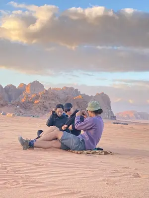 a group of people sitting on the beach at Wadi Rum, sands of Mars in Wadi Rum