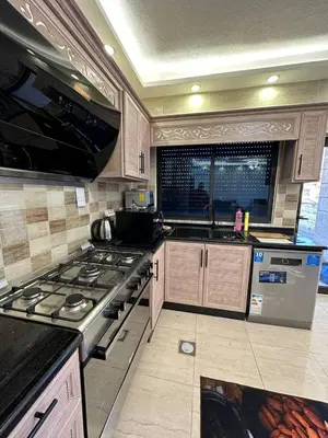 a kitchen with a stove and a sink in it at 3 bed rooms apartment - 3 غرف نوم مفروشة دوار المشاغل عمان in Amman