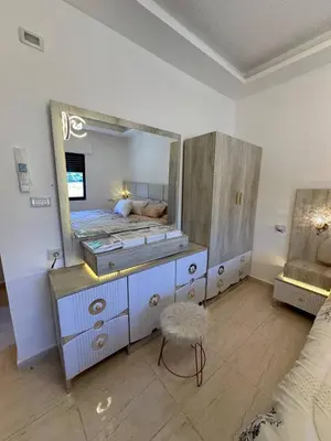 a bedroom with a large mirror and a bed at 3 bed rooms apartment - 3 غرف نوم مفروشة دوار المشاغل عمان in Amman