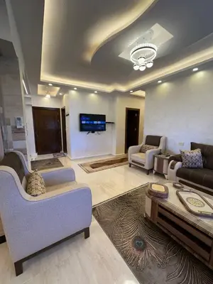 a large living room with couches and a tv at 3 bed rooms apartment - 3 غرف نوم مفروشة دوار المشاغل عمان in Amman