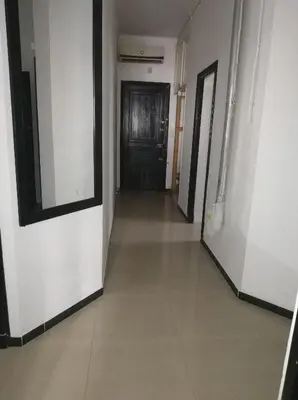 a hallway with a black door and a white wall at 89 inn in Amman