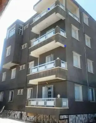 a tall building with balconies on the side of it at 89 inn in Amman