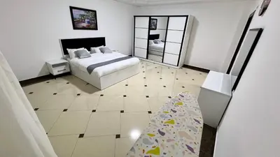 a bedroom with a bed and a mirror at شقة مفروشة اربع غرف نوم عبدون in Amman